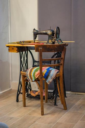 a sewing machine sitting on a wooden table with a chair at Casa di Pino EcoLodge Hotel in Žabljak