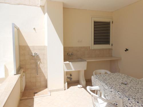 a small bathroom with a sink and a shower at Casa Sasha in Leuca