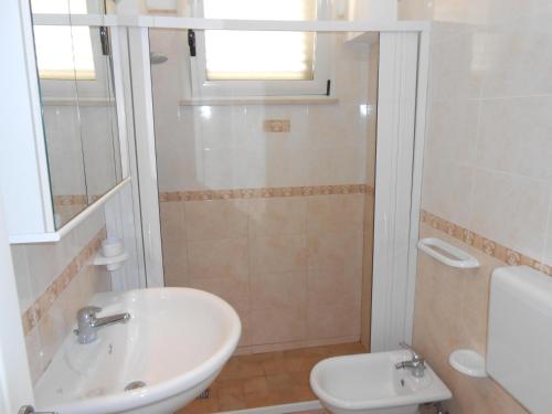a bathroom with a sink and a toilet at Casa Sasha in Leuca