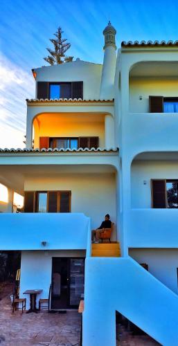 a building with a lighthouse on top of it at Blife Sun Hostel & Rooms in Faro