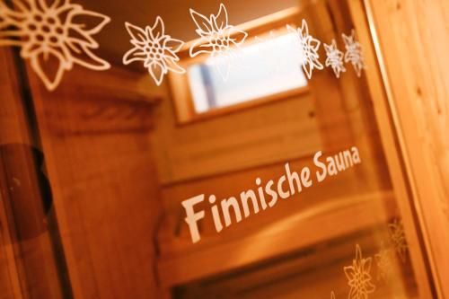 a sign on a glass door with snowflakes on it at Apart Alpenpension Maderer in Gaschurn