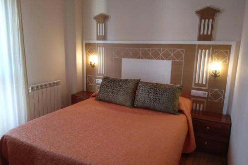 um quarto com uma cama com duas almofadas em Centrico apartamento en Noja con acceso a Spa em Noja