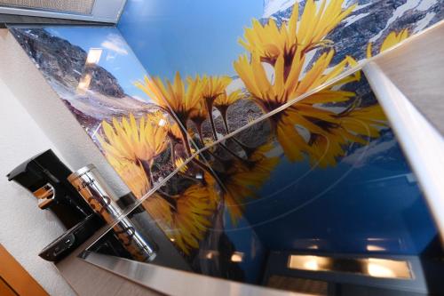a picture of a painting of flowers on a wall at Apart Alpenpension Maderer in Gaschurn