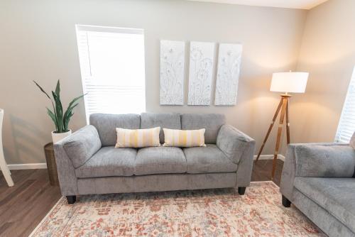a living room with a couch and a chair at Susitna Suites in Wasilla