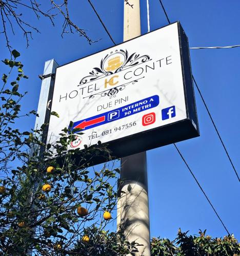 a sign for a hotel with an orange tree at Hotel Due Pini Conte in Angri