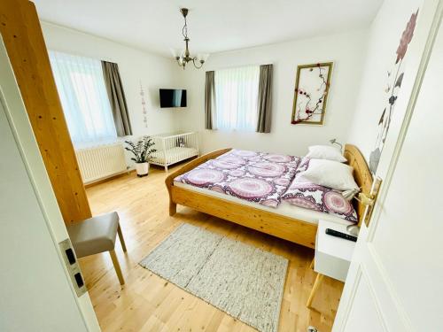 ein kleines Schlafzimmer mit einem Bett und einem Stuhl in der Unterkunft Ferienwohnung Fam. Lerch in Sankt Stefan ob Stainz