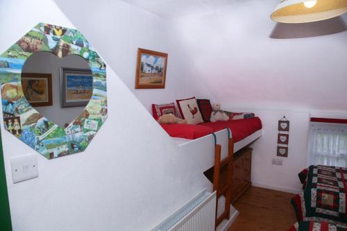 a bedroom with a bed and a mirror on the wall at Cobblers Cottage Creggan in Greencastle