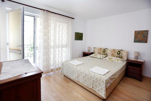 a bedroom with a bed and a large window at Lazur Sunrise in Burgas