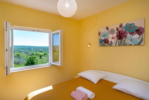 a bedroom with a bed and a window at Villa Matea - heated pool, peace, view in Pridraga
