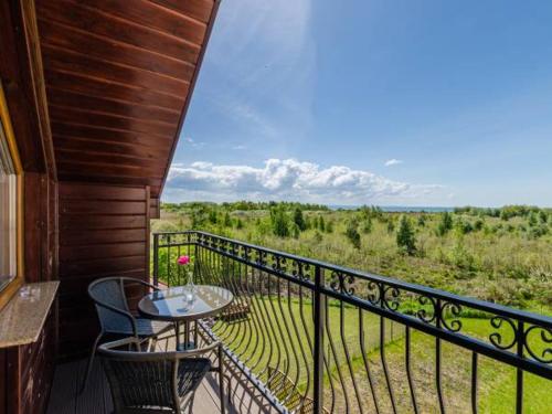 a balcony with a table and chairs and a view at Morska Fala in Jastarnia