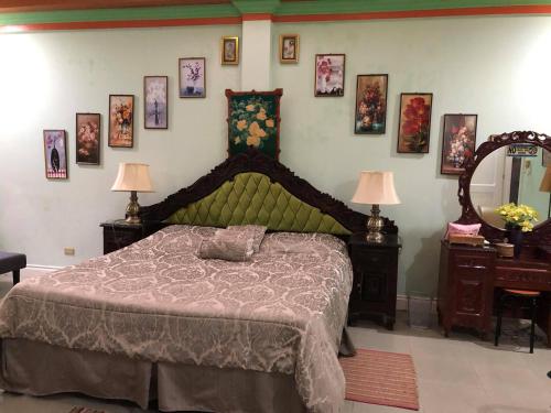 a bedroom with a bed and some pictures on the wall at Villa 301 B&B in Baclayon