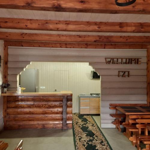 a kitchen with wooden walls and a counter with a mirror at Lucy in Yaremche