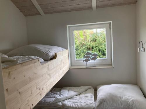 a bedroom with two beds and a window at Strandhus - Haus 37 in Grömitz