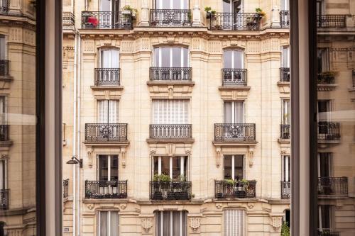 a facade of a building with balconies at Hôtel Maison Traversière in Paris