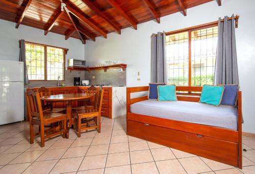 a bedroom with a bed and a table and a kitchen at Hotel Bahia Esmeralda in Potrero