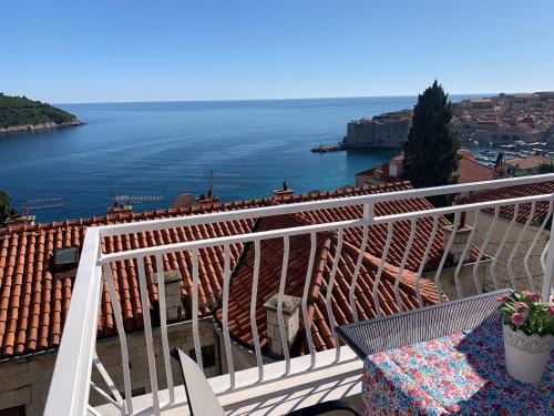 a balcony with a table and a view of the water at Villa Leoni in Dubrovnik