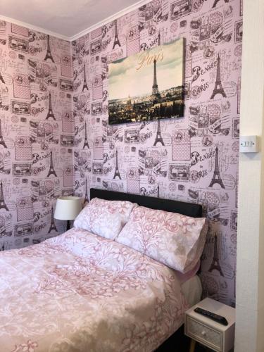 a bedroom with a bed and a wall covered in drawings at The Franklyn Hotel B&B in Blackpool