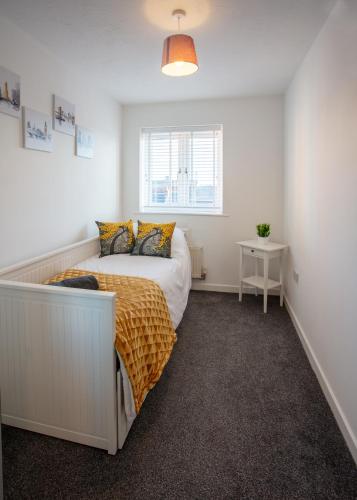 a bedroom with a bed and a window at Cherry Tree, Centrally Located Warrington Town Centre in Warrington