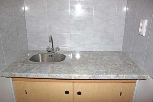 a kitchen sink with a granite counter top at F.E.Matras-Gasse 9 in Vienna