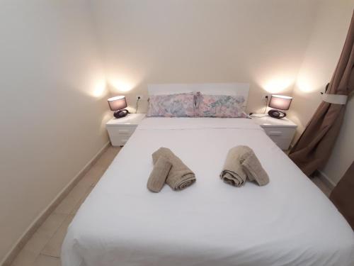 Posteľ alebo postele v izbe v ubytovaní Playa De Las Vistas