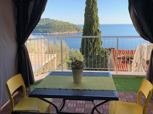a table and chairs on a balcony with a view of the ocean at Villa Leoni in Dubrovnik