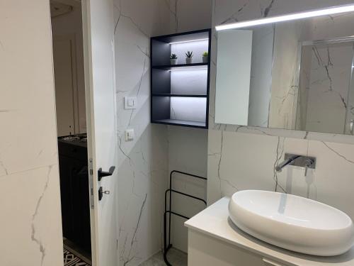 a white bathroom with a sink and a mirror at Villa Leoni in Dubrovnik