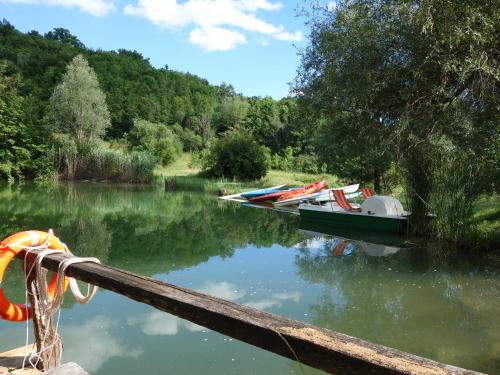 a group of boats are docked on a river at Agriturismo Monterosello in Città di Castello