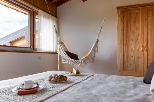 a hammock hanging on a bed in a room at Agriturismo Ai Dossi in Verona