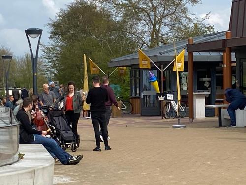 a group of people standing around in a park with flags at Vakantiehuisje Makkum NL - S15 in Makkum