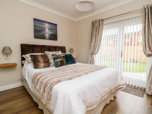 a bedroom with a large bed and a window at Cosy Corner in York