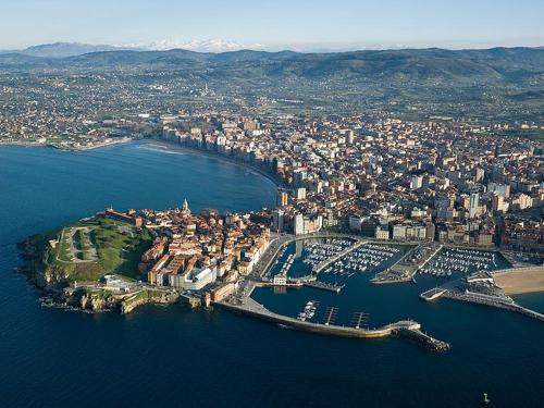 an aerial view of a city with a harbor at Mirador del Cantábrico in Lastres