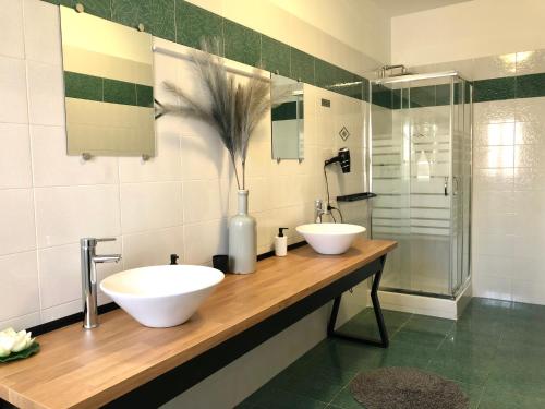 a bathroom with two sinks and a shower at Apartment Omnia in Marsala