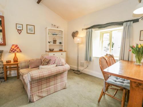 a living room with a couch and a table at Tyee Cottage in Carnforth