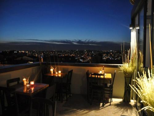 a patio with tables and chairs on a balcony at night at Taxim No18 Boutique Hotel in Istanbul