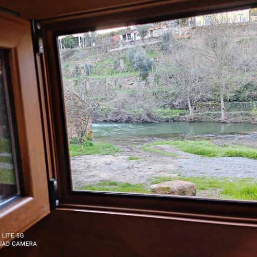 a view of a river from a window on a train at PampiHouse, casa de xisto junto ao rio in Pampilhosa da Serra