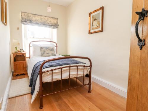 a bedroom with a bed and a window at Sunny Bank in Lancaster