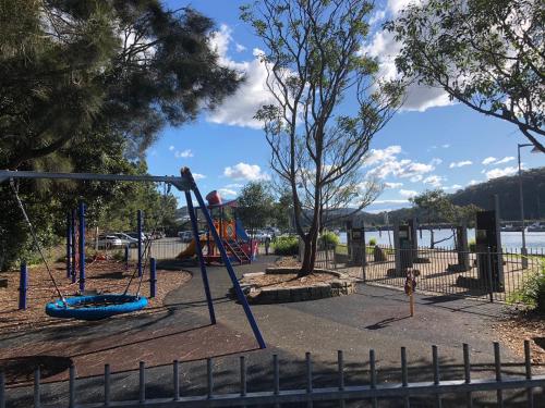 a park with a playground with a swing at Oasis on the Hawkesbury - Water Views in Brooklyn