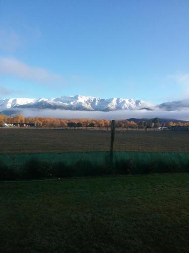 a view of snow covered mountains in a field at Best view on Westview in Hanmer Springs