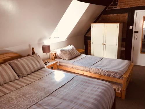 two beds in a room with a attic at Severn Valley Guest House in Bewdley