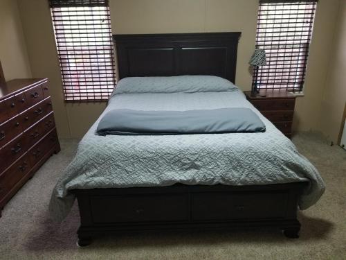 a bedroom with a bed and a dresser and two windows at Private Pet Friendly Home Near Exotic Deer Farm Close to Pigeon Forge, Gatlinburg TN in Sevierville