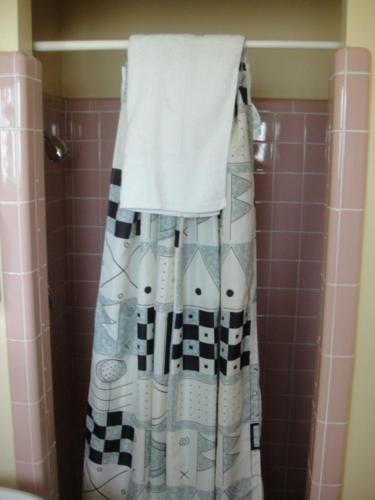 a shower curtain is hanging in a bathroom at Standish Motel in Standish