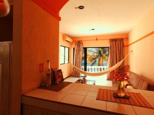 a room with a table with a vase of flowers at CANCUN PRIVATE APARTMENT in Cancún