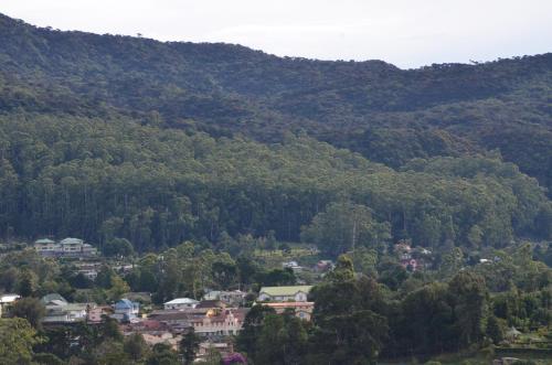a town in a valley with mountains in the background at Heaven Seven Nuwara Eliya in Nuwara Eliya