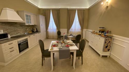 uma cozinha com uma mesa e cadeiras numa cozinha em Il Sogno di Hypnos em LʼAquila