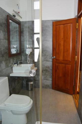 a bathroom with a toilet and a sink at Heaven Seven Nuwara Eliya in Nuwara Eliya