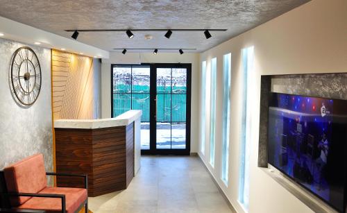 a hallway with a living room with a large tv at Vertoni Hotel Yerevan in Yerevan
