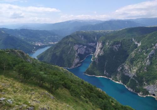a view of a river between two mountains at Apartments Ravno in Pluzine