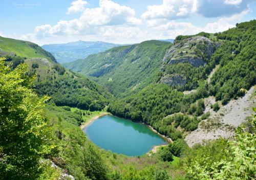 a view of a mountain valley with a lake at Apartments Ravno in Pluzine