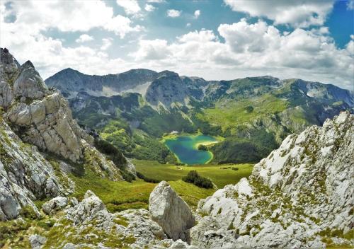 a view of a mountain valley with a lake at Apartments Ravno in Pluzine