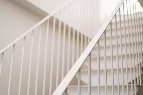 a white staircase with white railings at Debambú Atarazanas in Málaga